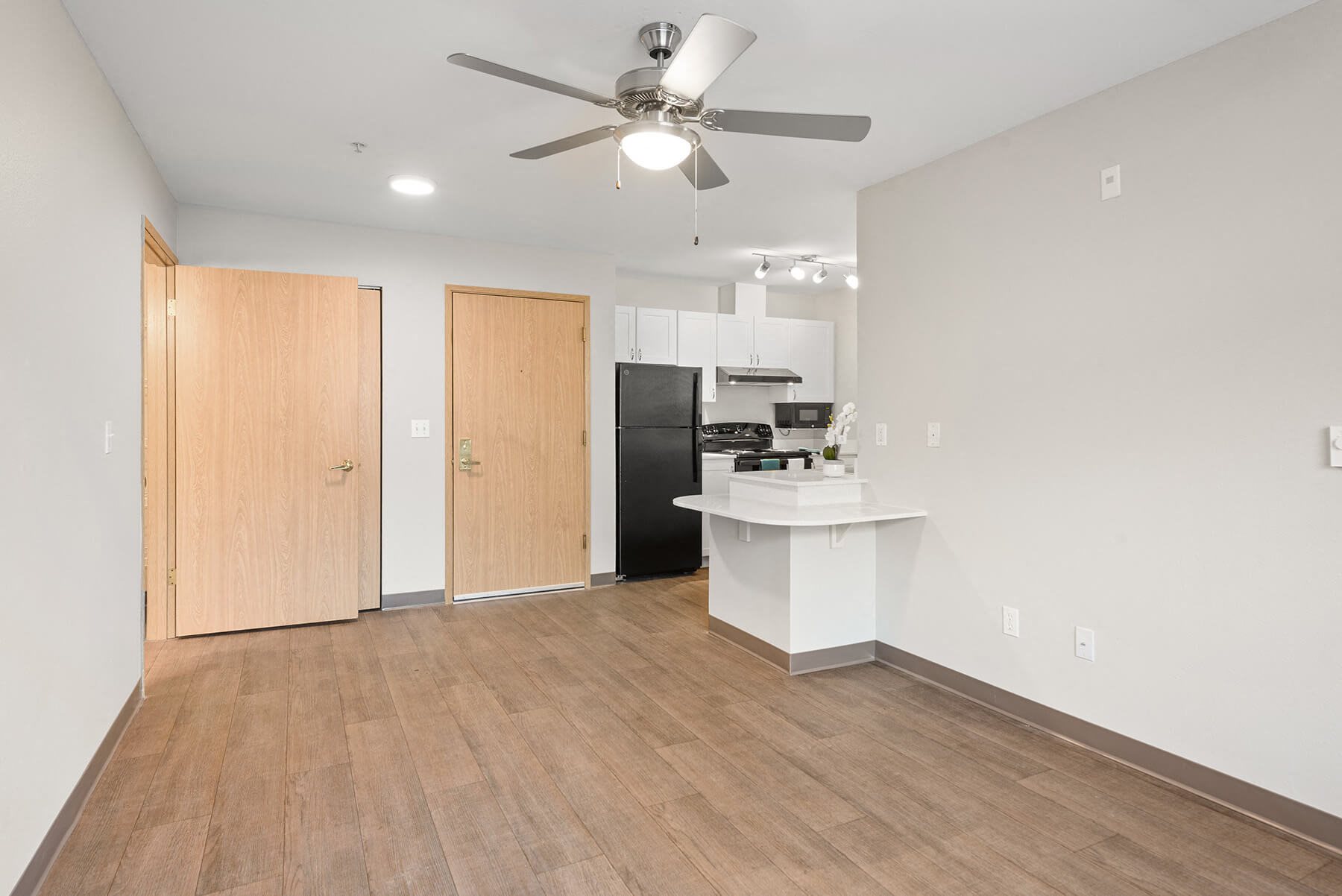 Upgraded kitchen and living room at Meridian Court Apartments in Federal Way WA